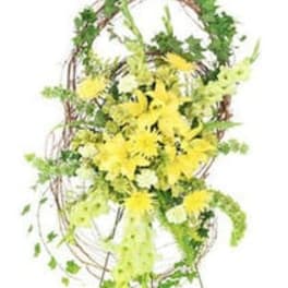Yellow flowers arranged on a tall decorative stand with greenery