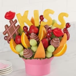 Candy bouquet in a pink box with "KISS" letters and chocolate pieces