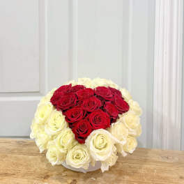 Heart-shaped bouquet of red and white roses in a white box
