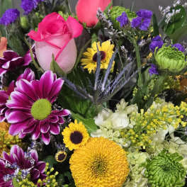 Bright mixed bouquet with pink roses, yellow and green chrysanthemums, and purple accents