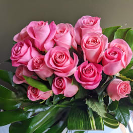 Bouquet of pink roses with broad green leaves