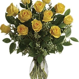 Yellow roses arranged in a clear glass vase