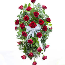 Cascade of red roses with white ribbon and baby's breath