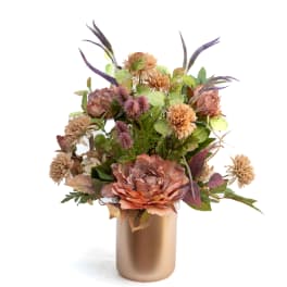 Arrangement of peach and mauve flowers in a gold vase