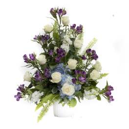 White roses, blue hydrangea, and purple alstroemeria in a white vase