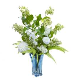 White floral arrangement in a blue glass vase