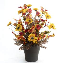 Artificial sunflower arrangement in a black pot with autumn leaves and berries