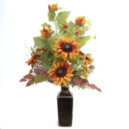 Orange sunflower arrangement in a dark vase