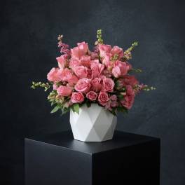 Pink rose bouquet in a white geometric vase