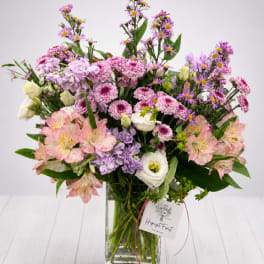 Mixed pink and purple bouquet in a clear glass vase