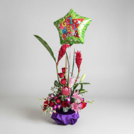 Tall floral arrangement with a green "Get Well Soon" balloon and purple base wrap