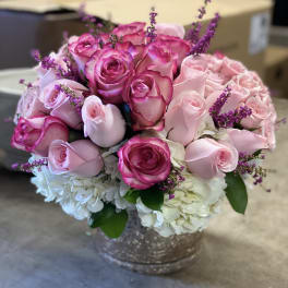 Pink and white rose bouquet in a silver vase