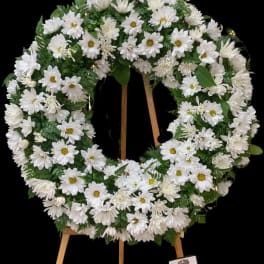 White daisy wreath on a wooden easel