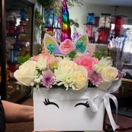Unicorn-themed flower box with pastel roses and daisies
