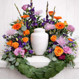Colorful floral wreath with a white urn in the center