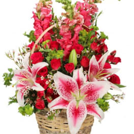 Basket arrangement of red roses and pink lilies