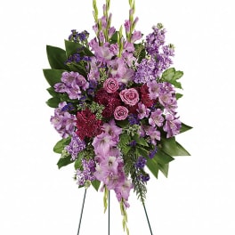 Tall purple floral standing spray on a wire easel