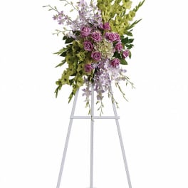 Tall floral spray on a metal easel with purple and green flowers