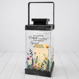 Black lantern with a memorial message and small floral print