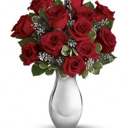 Red roses arranged in a silver vase