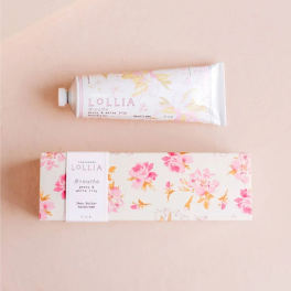 Hand cream tube and floral box on a pale pink background