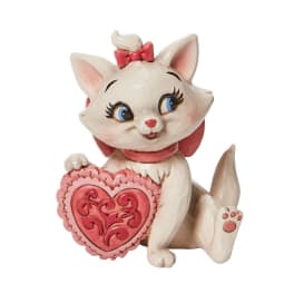 Ceramic cat figurine holding a pink heart