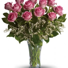 Pink roses arranged in a clear glass vase