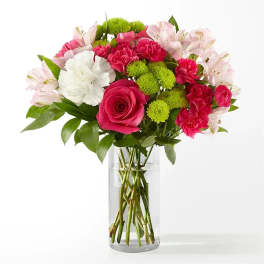 Bouquet of pink and white flowers in a clear glass vase