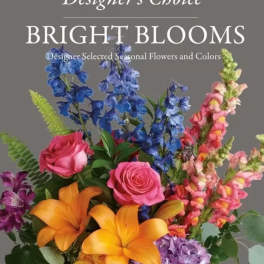 Bright mixed bouquet with roses, lilies, and tall blue and pink blooms