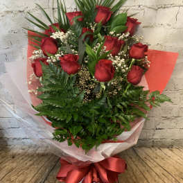 Bouquet of red roses with baby's breath and a red ribbon wrap