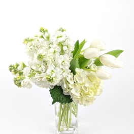 White flowers arranged in a clear glass vase