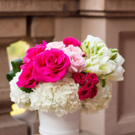 Pink and white rose bouquet in a white vase