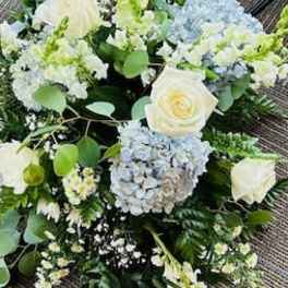 White and pale blue wedding bouquet with roses and hydrangeas