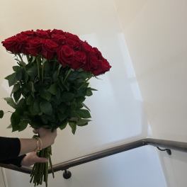Large bouquet of red roses held by hand