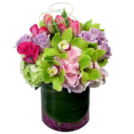 Bouquet of pink and lavender flowers in a dark glass vase