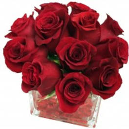 Red roses arranged in a clear square glass vase.
