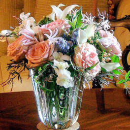 Pink and white flower arrangement in a clear glass vase