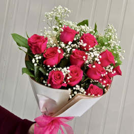 Bouquet of hot pink roses with white baby's breath and pink ribbon