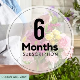 Person holding a pastel mixed flower bouquet with a 6 months subscription label