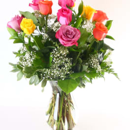 Bouquet of multicolored roses in a clear glass vase