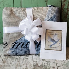 Wrapped gift with a white bow and sympathy card