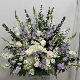 Large white and lavender floral arrangement in a vase
