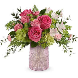 Pink roses and white lilies arranged in a pink textured vase
