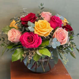Bouquet of multicolored roses in a glass vase