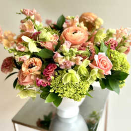 Peach and pink mixed bouquet in a white vase