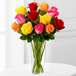 Bouquet of multicolored roses in a clear glass vase