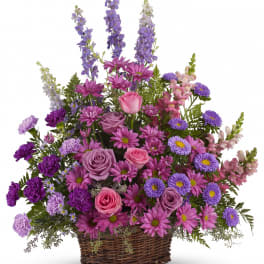 Basket arrangement of pink and purple flowers with tall lavender spikes