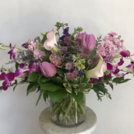Pink and purple mixed bouquet in a clear glass vase
