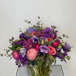 Mixed purple and pink bouquet in a clear glass vase