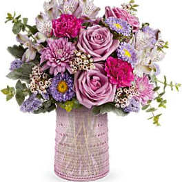 Lavender and pink bouquet in a textured pink vase